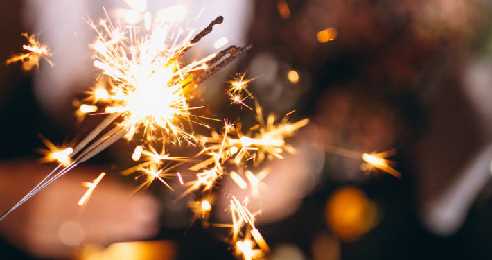 People holding christmas lights